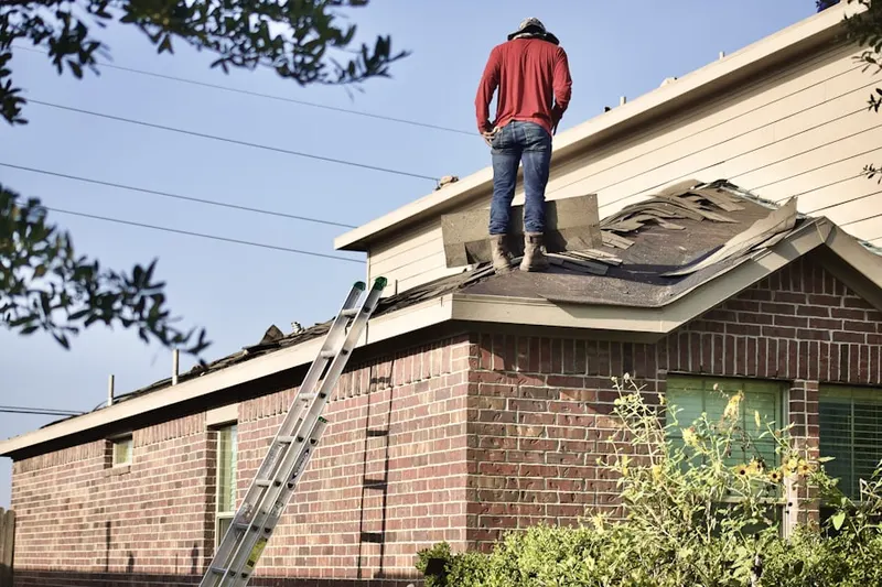 Professional roofer working on a residential roof in Rover Mill Estates